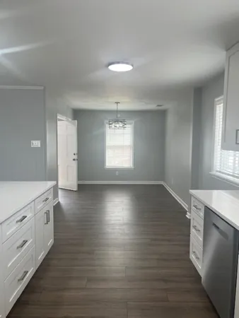 a view of a kitchen and wooden floor