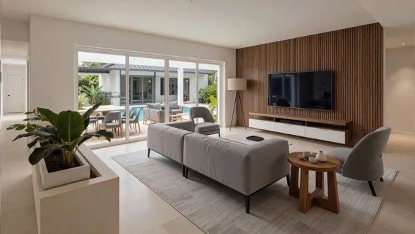 a living room with furniture a large window and a table