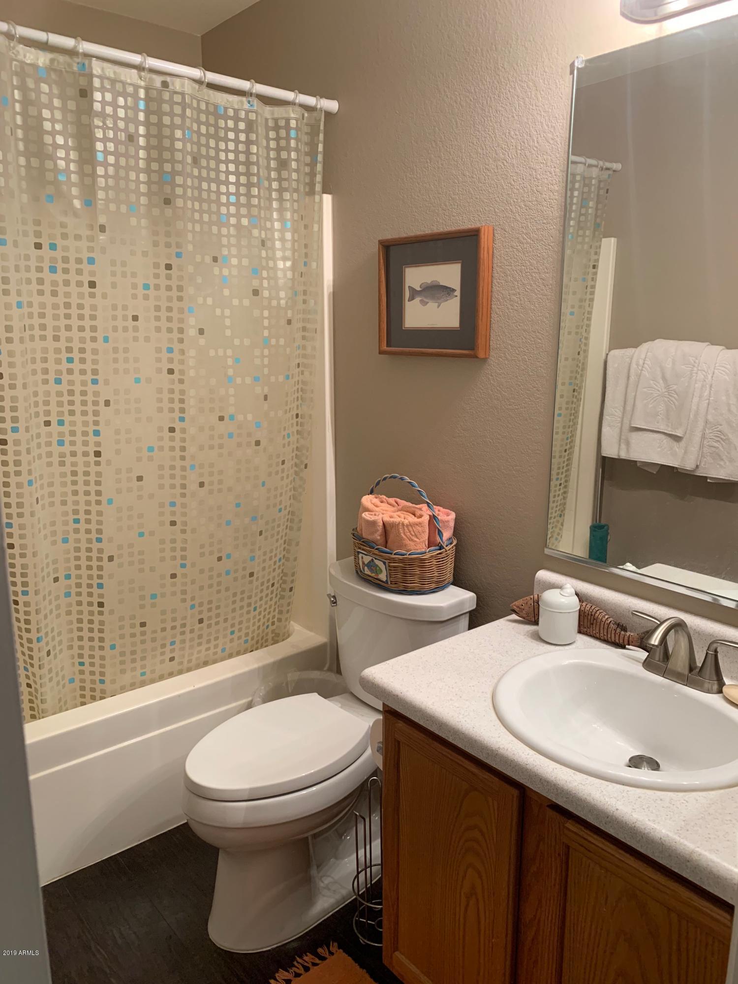 2515 West Romley Road Phoenix, AZ 85041 - Photo 11 of 20 a bathroom with a sink a toilet and shower