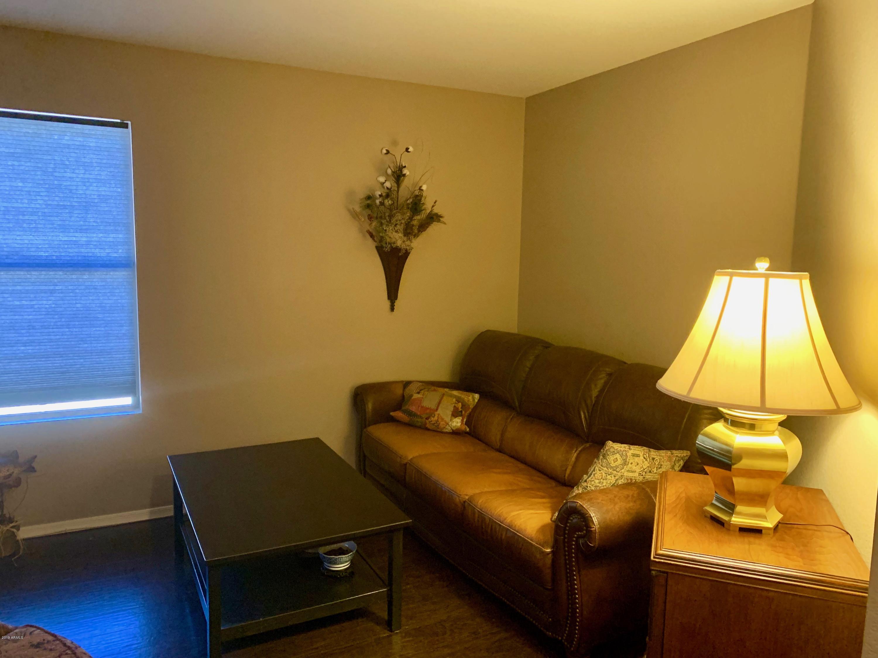 2515 West Romley Road Phoenix, AZ 85041 - Photo 8 of 20 a living room with a couch