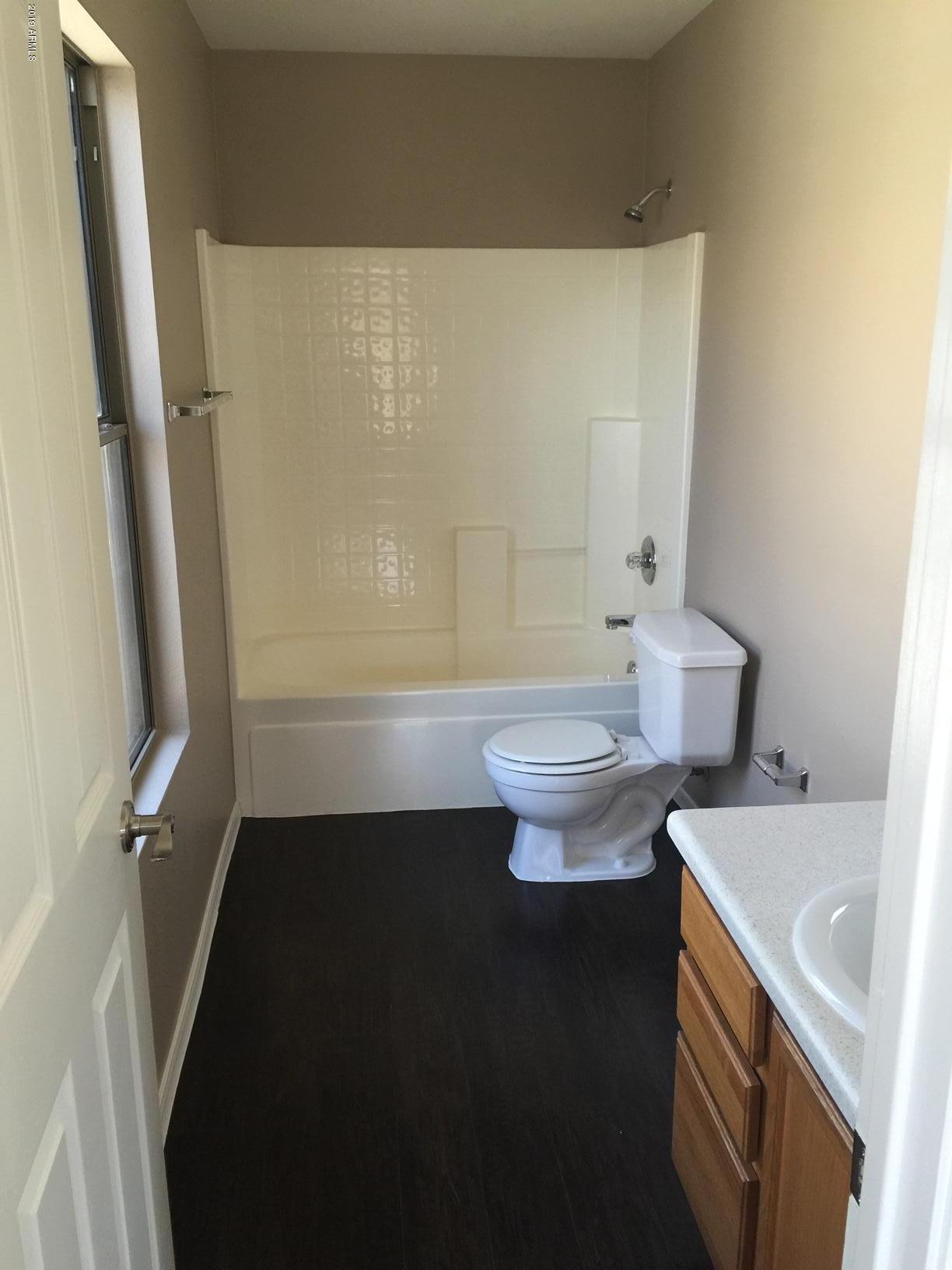 2515 West Romley Road Phoenix, AZ 85041 - Photo 9 of 20 a bathroom with a sink toilet and shower