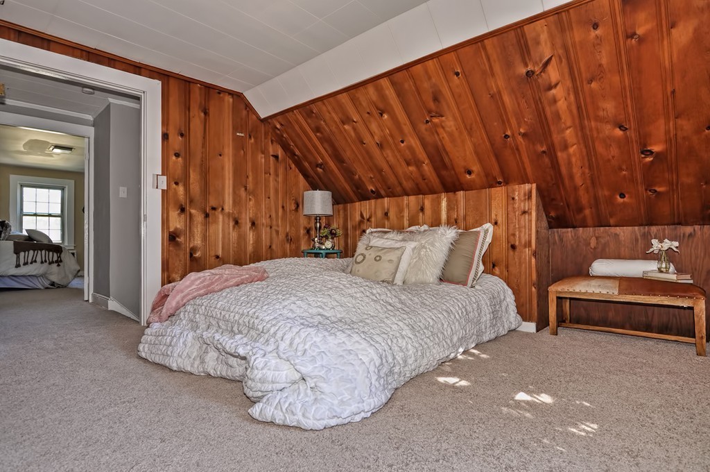 1054 Trapelo Road Waltham, MA 02451 - Photo 8 of 16 a bedroom with a bed and a couch