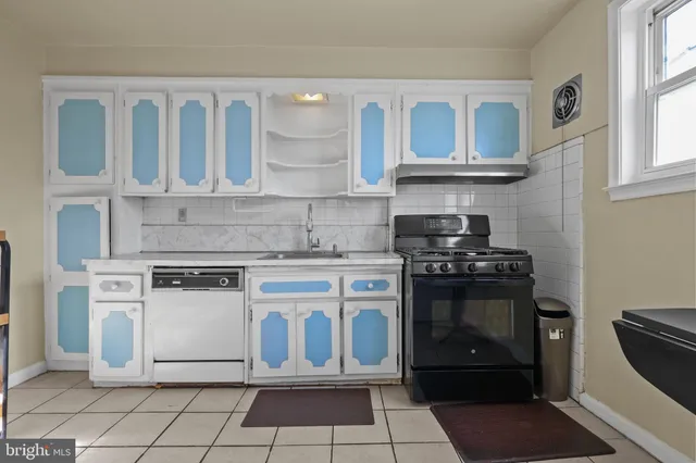 a white stove top oven sitting inside of a kitchen