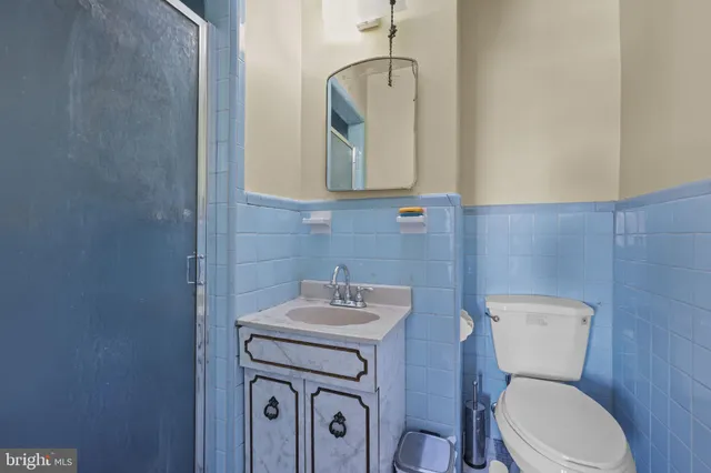 a bathroom with a toilet sink and mirror