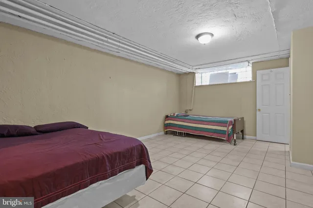 a bedroom with a bed and a desk