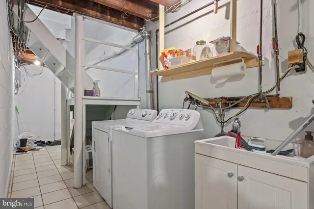 a front view of a building with lot of cars and trees