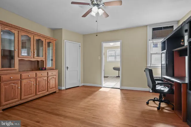 a view of a workspace with furniture and a window