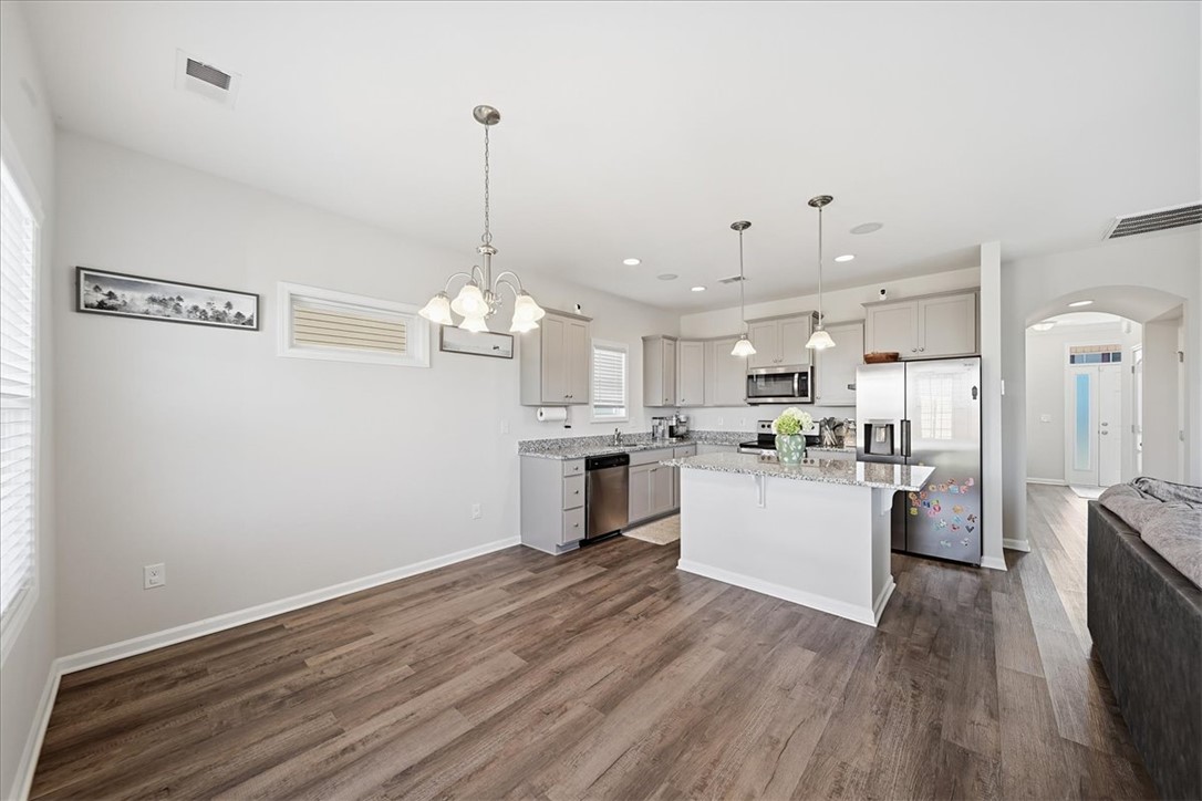 403 Seaborn Circle Pendleton, SC 29670 - Photo 12 of 47 The open-concept kitchen and dining area features abundant natural light, creating a welcoming atmosphere for entertaining.