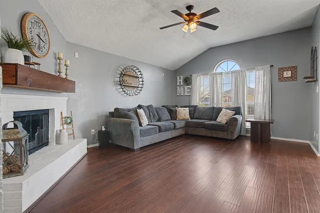 a living room with furniture and a fireplace