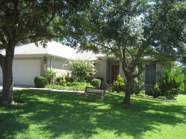 a view of a house with a backyard