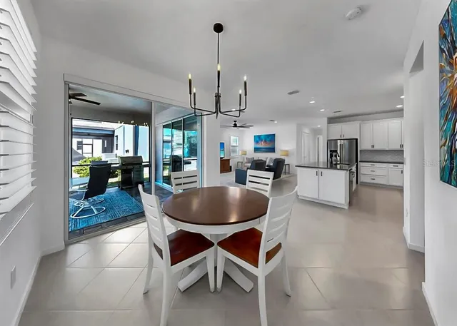 a dining room with furniture and a kitchen view