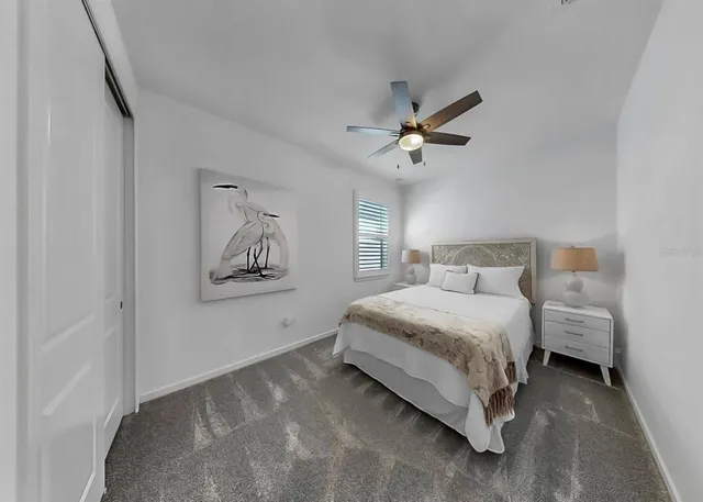 a spacious bedroom with a bed and a chandelier