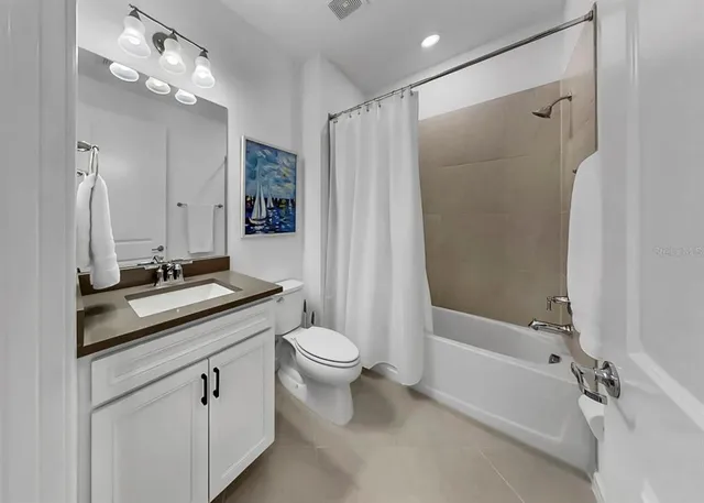 a utility room with cabinets washer and dryer