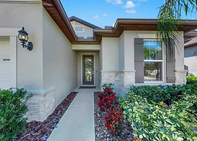 a front view of a house with a flower garden