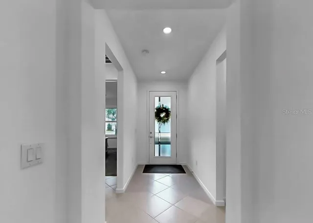 a view of a hallway with wooden shelves