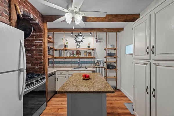 a kitchen with stainless steel appliances granite countertop a stove and cabinets