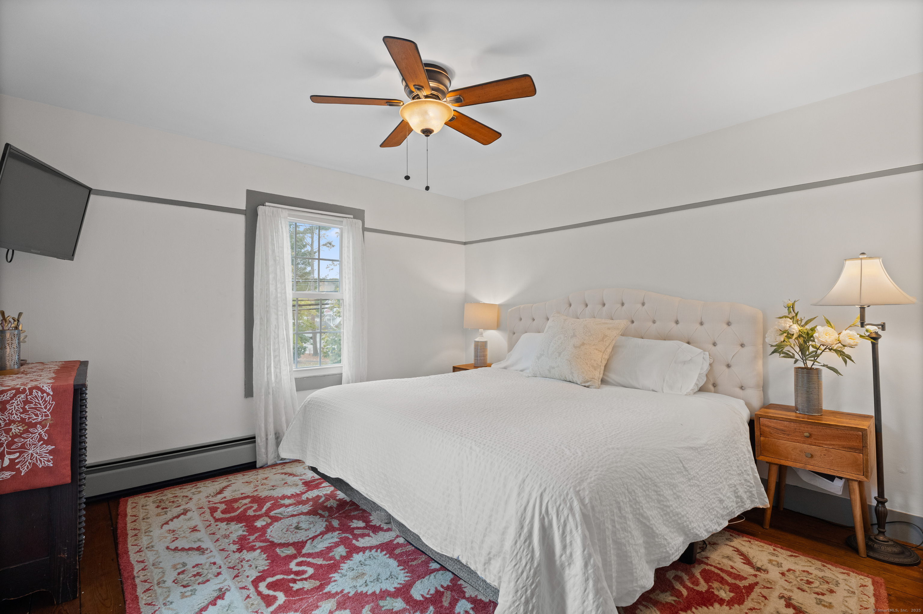 209 Main Street Deep River, CT 06417 - Photo 18 of 40 a bedroom with a bed and a lamp on the dresser
