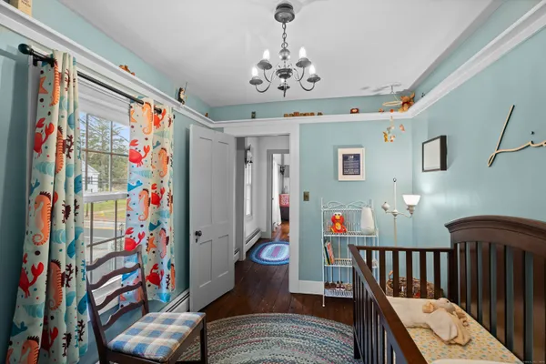 a view of a hallway with a dining table chairs and couches