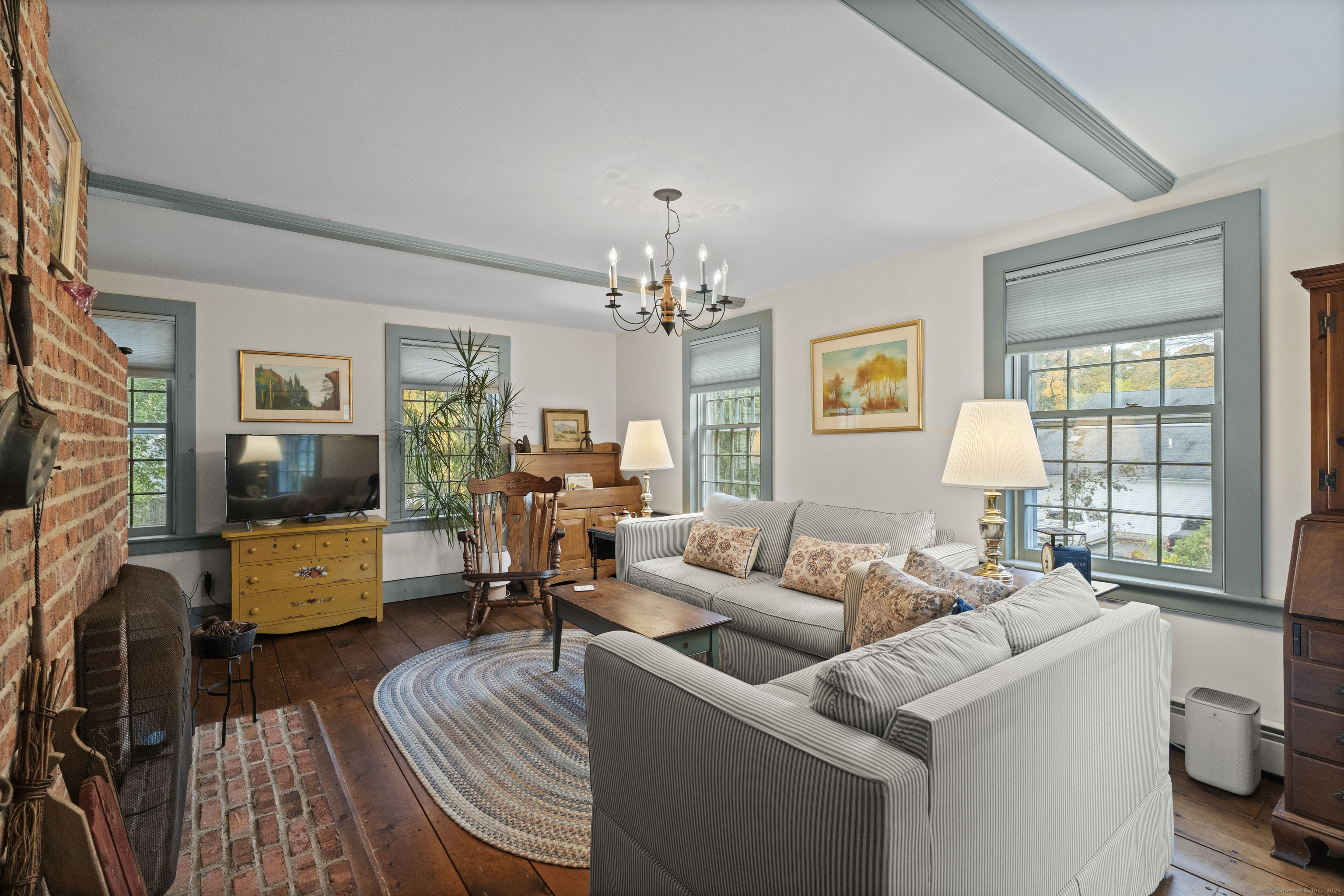 209 Main Street Deep River, CT 06417 - Photo 26 of 40 a living room with furniture and a chandelier