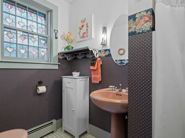 a bathroom with a sink a mirror and a window