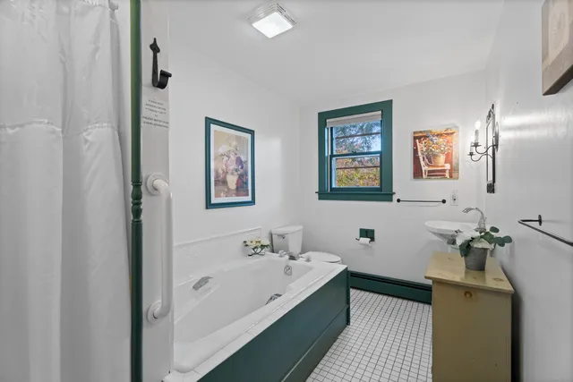 a spacious bathroom with a tub and sink
