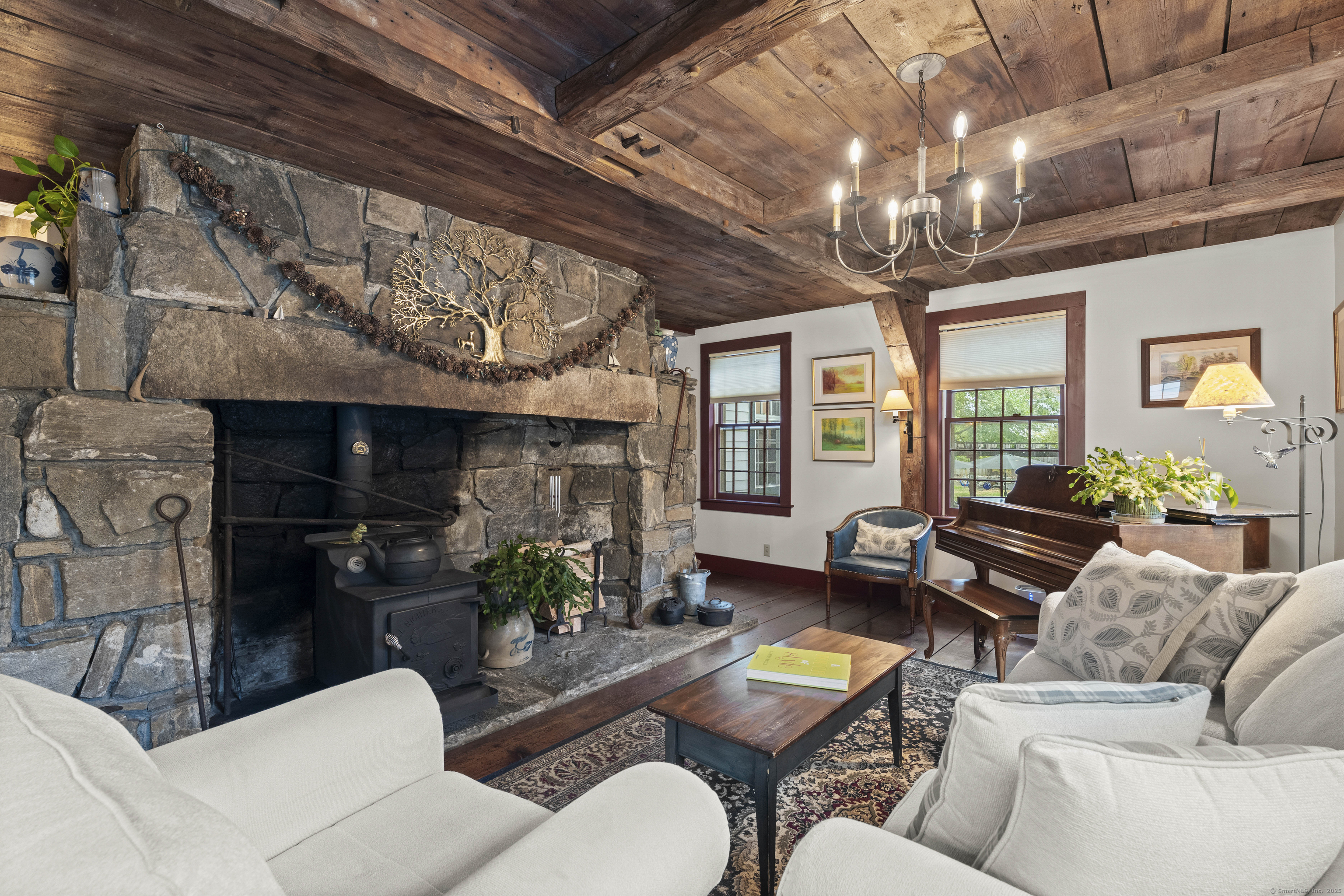 209 Main Street Deep River, CT 06417 - Photo 32 of 40 a living room with furniture a chandelier and a fireplace
