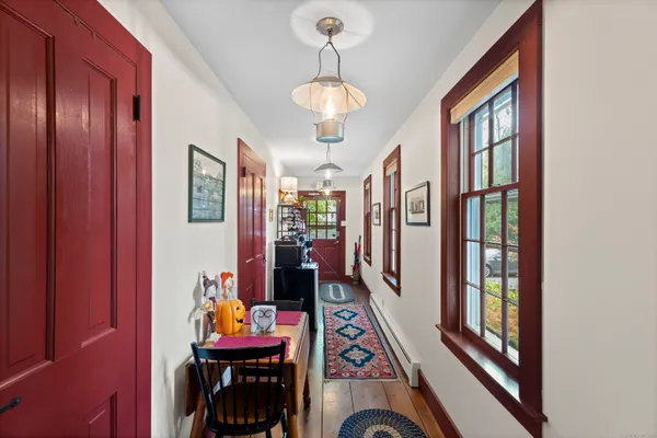 a view of a hallway with furniture and chandelier