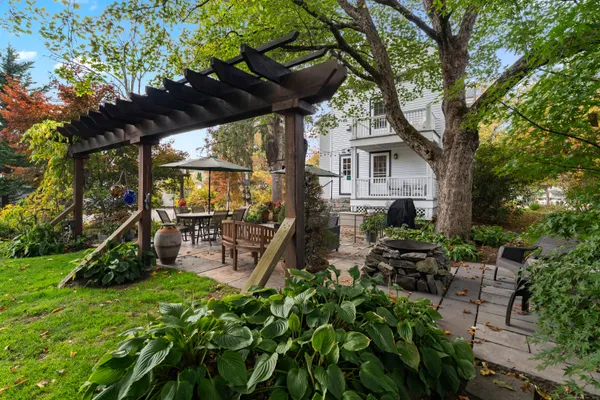 a view of a chairs and table in a backyard