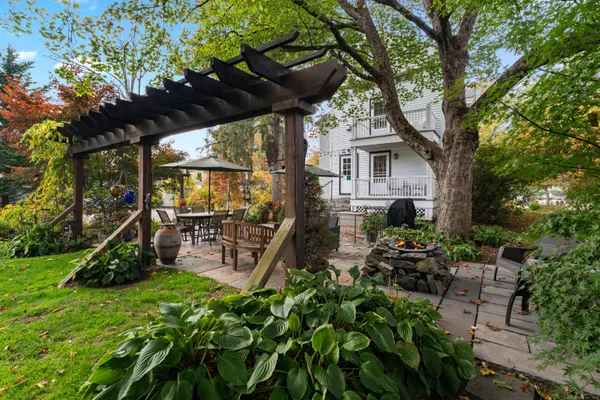 a view of a chairs and table in a backyard