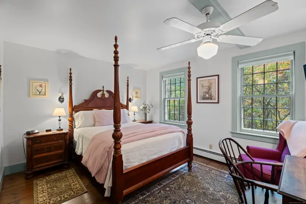 a bedroom with a bed chair and a window