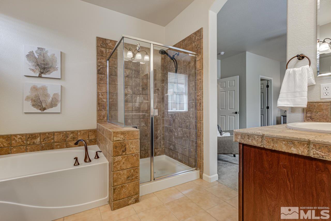 1808 Wind Ranch Road, Unit B Reno, NV 89521 - Photo 18 of 31 a bathroom with a granite countertop tub shower and sink