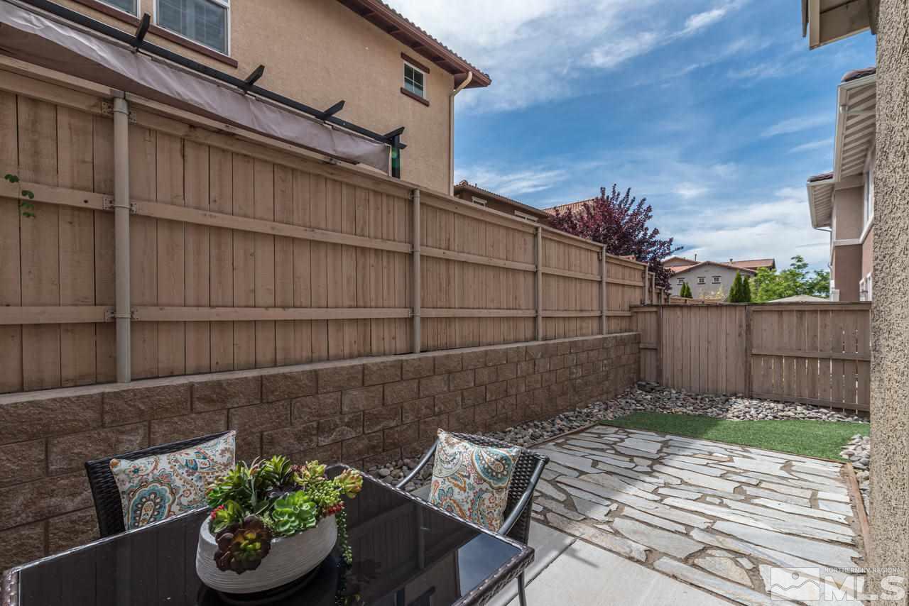 1808 Wind Ranch Road, Unit B Reno, NV 89521 - Photo 23 of 31 a view of a backyard with chair and potted plants