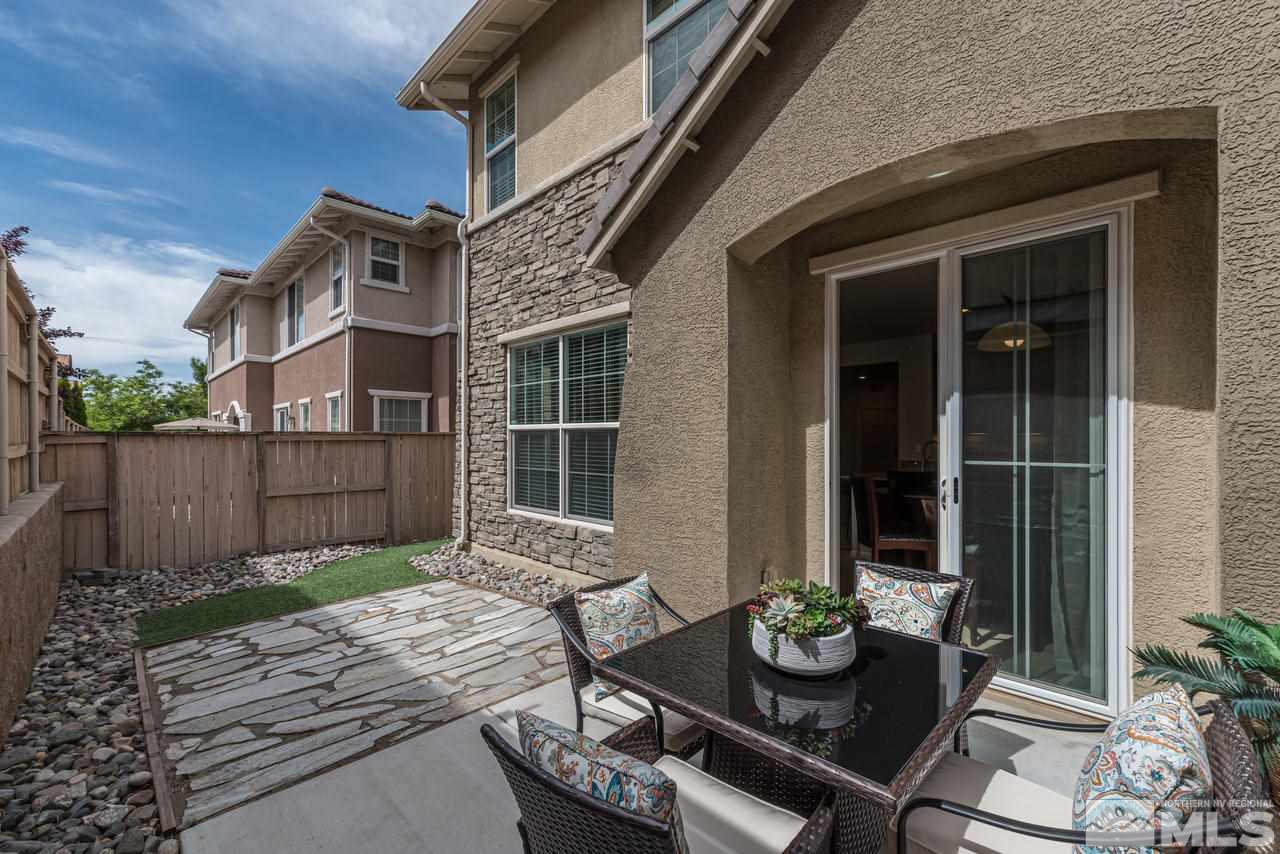1808 Wind Ranch Road, Unit B Reno, NV 89521 - Photo 24 of 31 a view of a dinning table and chairs in patio of the house
