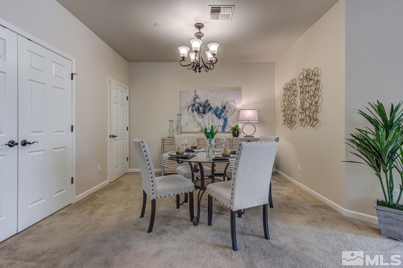 1808 Wind Ranch Road, Unit B Reno, NV 89521 - Photo 5 of 31 a view of a dining room with furniture and chandelier
