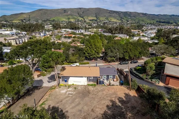 an aerial view of a house with a yard