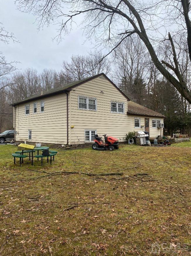 36 Halsey Reed Road Monroe Township, NJ 08831 - Photo 3 of 9 a backyard of a house with table and chairs