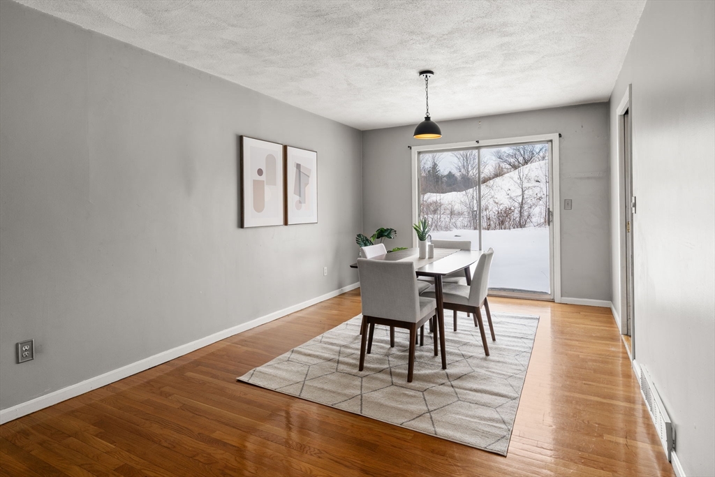 9 April Lane, Unit 9 Lexington, MA 02421 - Photo 11 of 38 a view of a dining room with furniture window and wooden floor
