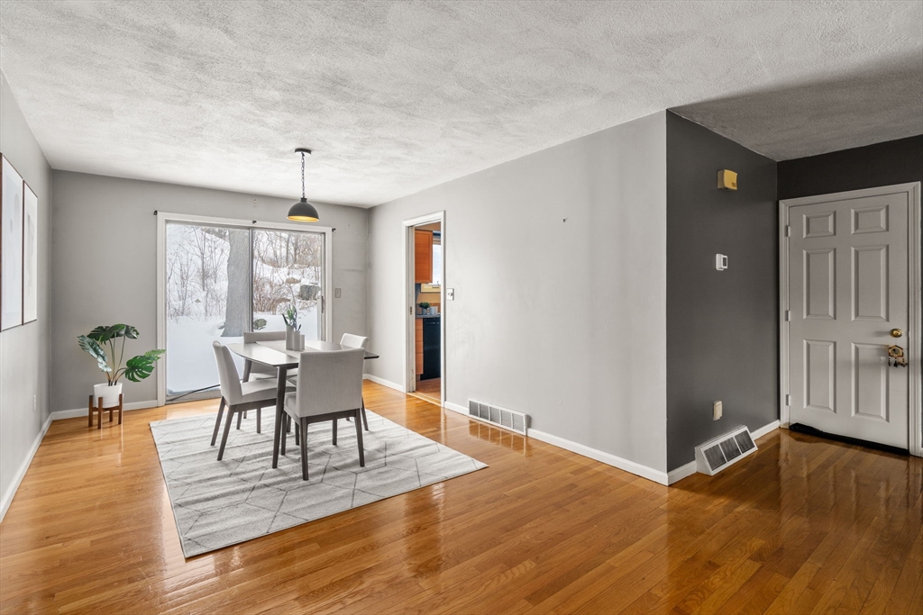 9 April Lane, Unit 9 Lexington, MA 02421 - Photo 12 of 38 a view of a dining room with furniture and wooden floor