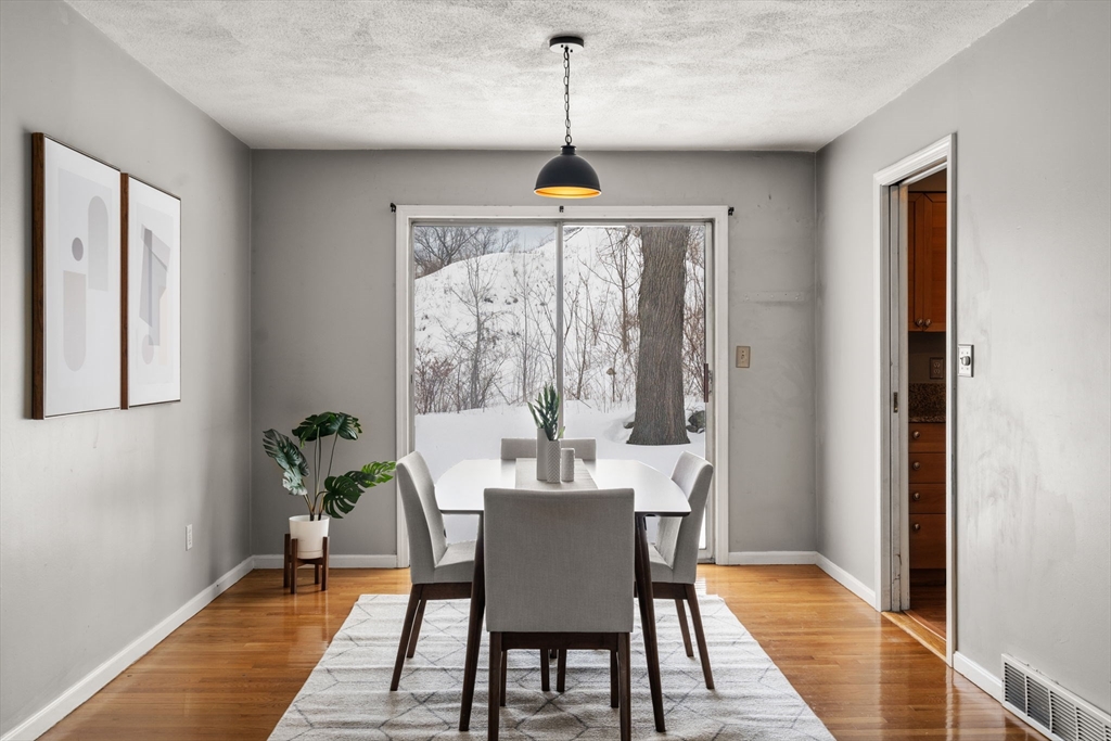 9 April Lane, Unit 9 Lexington, MA 02421 - Photo 13 of 38 a dining room with furniture window wooden floor