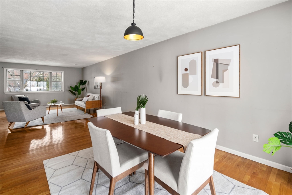 9 April Lane, Unit 9 Lexington, MA 02421 - Photo 14 of 38 a view of a dining room with furniture window and wooden floor