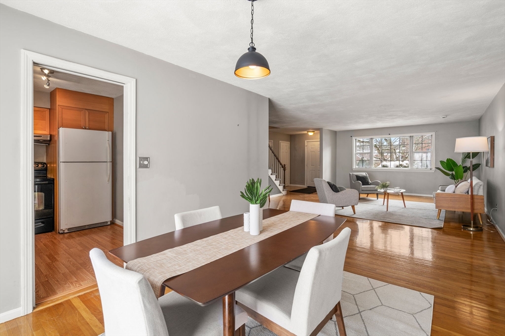 9 April Lane, Unit 9 Lexington, MA 02421 - Photo 15 of 38 a view of a dining room with furniture window and wooden floor