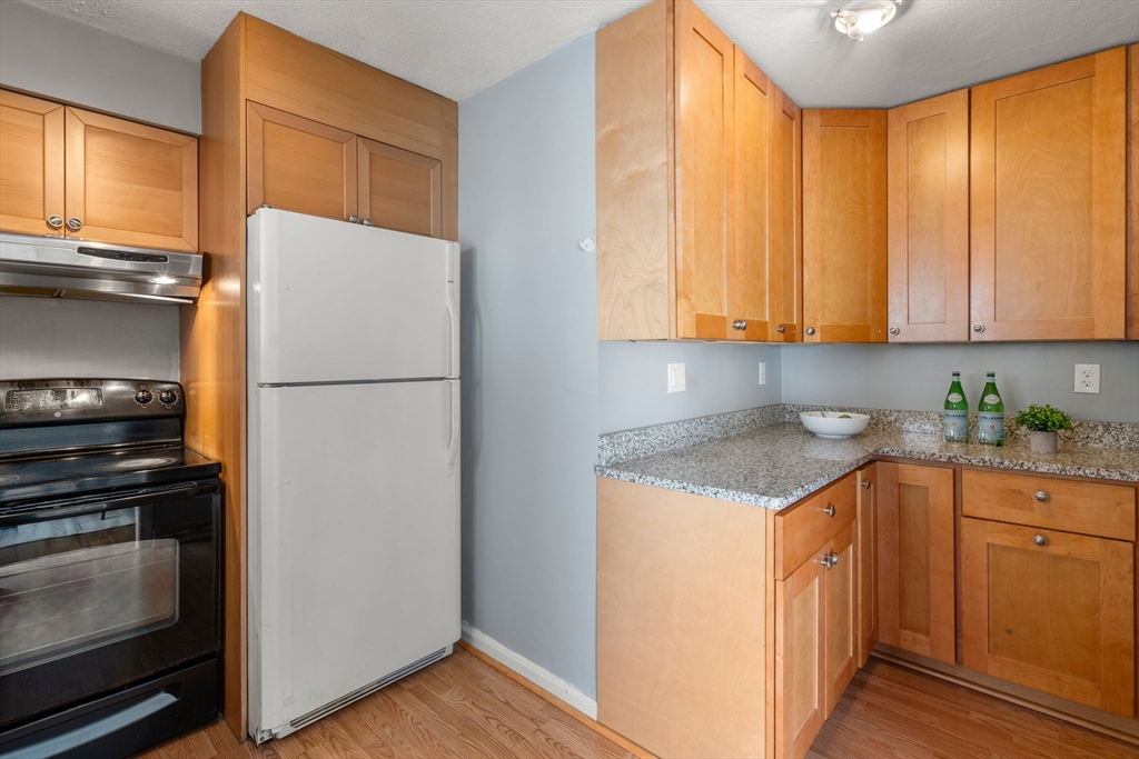 9 April Lane, Unit 9 Lexington, MA 02421 - Photo 17 of 38 a kitchen with a refrigerator sink and cabinets