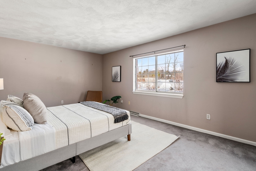 9 April Lane, Unit 9 Lexington, MA 02421 - Photo 22 of 38 a bedroom with a bed and a window