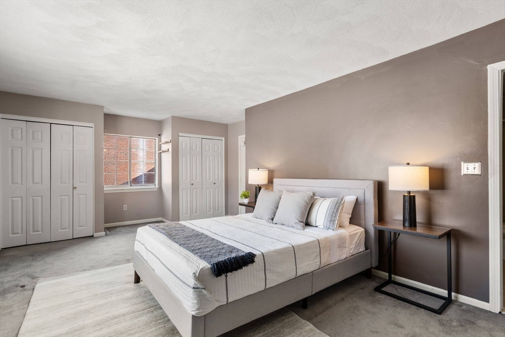 9 April Lane, Unit 9 Lexington, MA 02421 - Photo 23 of 38 a bedroom with a bed and a night stand
