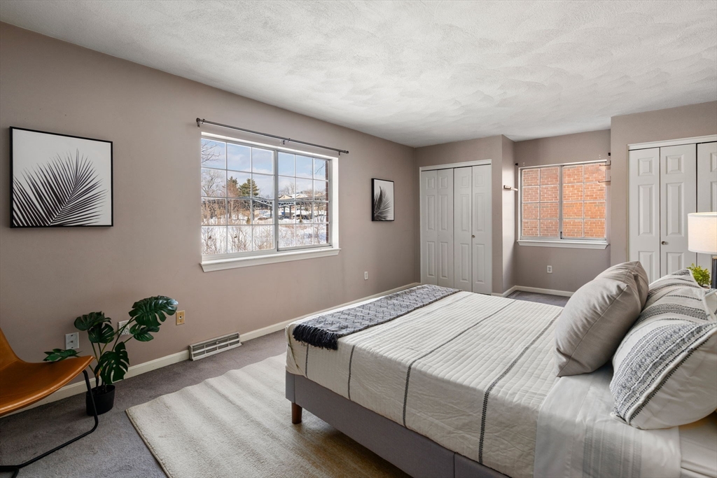 9 April Lane, Unit 9 Lexington, MA 02421 - Photo 24 of 38 a bedroom with a bed and a window