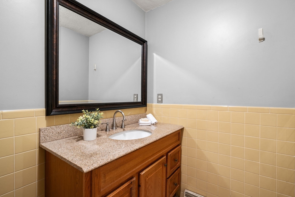 9 April Lane, Unit 9 Lexington, MA 02421 - Photo 26 of 38 a bathroom with a sink and a mirror