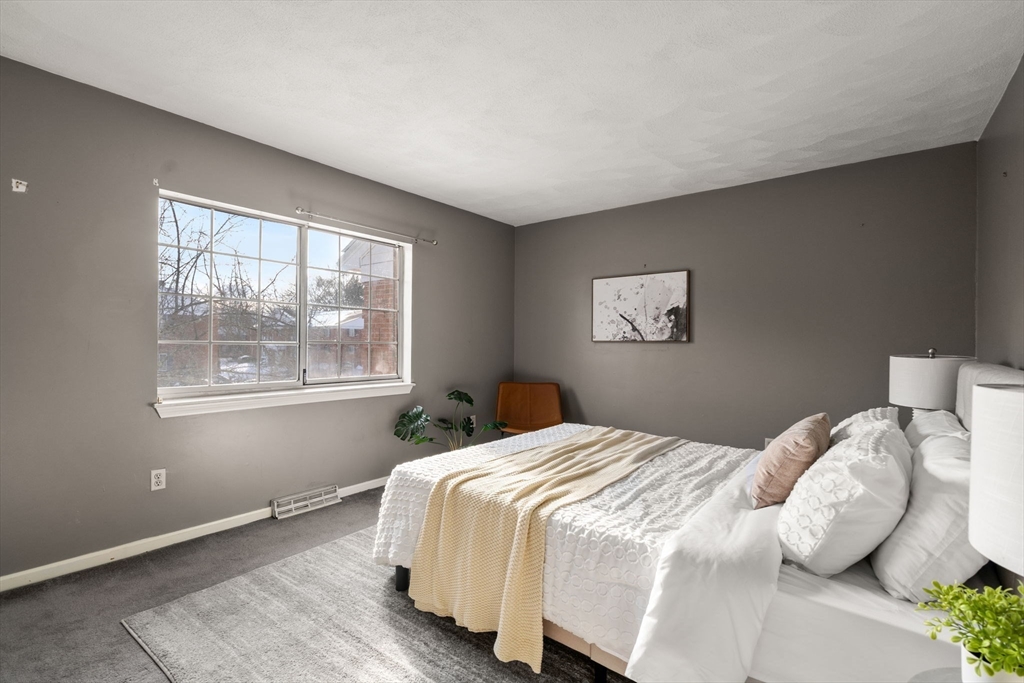 9 April Lane, Unit 9 Lexington, MA 02421 - Photo 28 of 38 a bedroom with a bed and a window