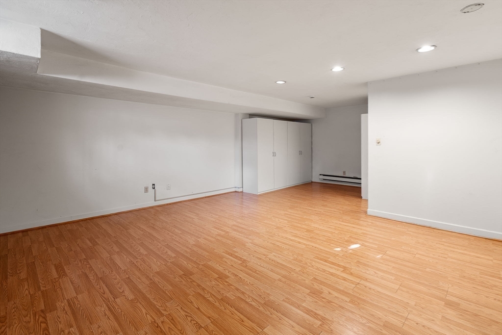 9 April Lane, Unit 9 Lexington, MA 02421 - Photo 33 of 38 a view of an empty room with wooden floor