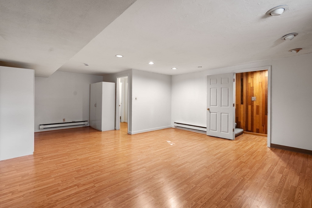 9 April Lane, Unit 9 Lexington, MA 02421 - Photo 34 of 38 a view of empty room with wooden floor