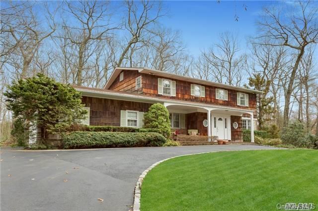 56 White Oak Tree Road Laurel Hollow, NY 11791 - Photo 1 of 1 a front view of a house with a yard